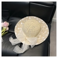 Detailed view of floral embroidery and white mesh bow on beige straw sun hat - Sun Straw Hat With Bow Decoration