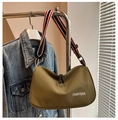Detail of olive green canvas crossbody bag with striped wide strap and dual zippers - Green