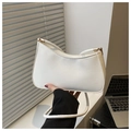 Detail of a minimalist white half-moon shoulder bag with sleek leather and gold hardware - White