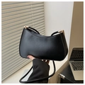Detail of minimalist black hobo bag with gold hardware and smooth leather finish - Black