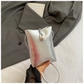 Detail of silver mini crossbody bag featuring a large pearl clasp on the front flap - Silver