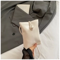 Detailed view of cream mini crossbody bag featuring a large pearl clasp and PU leather - Off White