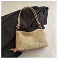 Detail of hand-woven straw bag with leather strap knot and FANYISSA brand label - Khaki