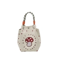 Cream knitted tote bag featuring a red mushroom pattern and stylish braided handles - Mushroom Style