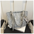 Silver-grey tote bag with pleated texture and fashion scarf accessory on white books - Silver