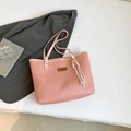 Pink tote bag with crocodile texture and woven rope charm displayed on a white surface - Style With Charm / Pink With Charm
