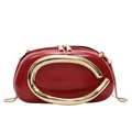 Glossy red handbag with oversized gold C-shaped metal handle and chain strap - Red