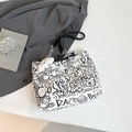 White canvas tote bag featuring black graffiti patterns with metallic chain handles - With Charm / White