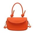 Minimalist orange leather handbag with knot handle design and golden metal strap clips - Orange