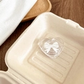 Close-up of heart-shaped phone grip with white 3D bow on a beige paper tray - Style 3 White Bowknot