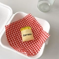 Close-up of a creative banana-shaped phone socket in a cute beige fabric bag design - Banana Bag Style