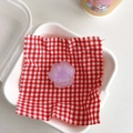 Close-up of translucent purple cat paw phone grip featuring a heart detail on checkered fabric - Purple Core