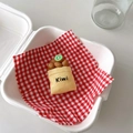 Macro detail of a creative kiwi fruit phone stand inside a fresh delivery box - Kiwi Bag Style