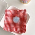 Close-up of light blue cat paw phone socket with heart detail on checkered napkin - Blue Core