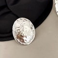 Close-up of silver oval phone socket holder with creative metallic tin-foil texture design - Oval Shape - Shiny Silver
