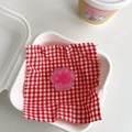 Detail of pink cat paw phone grip with heart design inside a plaid lined container - Sandwich Rose Red