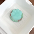 Macro shot of mint green 3D cat paw phone grip featuring Good Luck engraving detail - Matte Cat Paw - Green