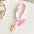 Detail of pink woven phone lanyard with cute teddy dog pendant and leather smiley fastener - Pink Poodle + Pink Gasket