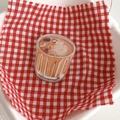Detail view of a creative latte-shaped acrylic phone grip on a red plaid picnic background - Shaking Bracket - Milk Tea/Latte