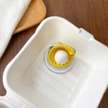 Macro detail of 3D baseball and yellow glove phone socket on a white tray - Magnetic Baseball Yellow