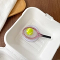 Detailed close-up of a mini tennis racket and ball phone grip on a round base - Magnetic Tennis Racket Pink
