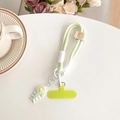 Detail view of woven light green phone lanyard with heart fishbone charm and spacer - Green (Smile Lanyard + Gradient Fishbone) / Green
