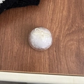 Dettaglio del supporto per telefono in peluche bianca con fiocco su legno scuro - Supporto Trasparente-Fiocco in Pelliccia di Visone-Bianco