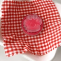Detail of pink cat paw phone grip with matte texture and heart-shaped relief detail - Rose Red