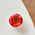 Macro view of a 3D resin tomato phone socket holder with a glossy crystal finish - Transparent Stand Crystal Glass Tomato