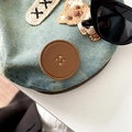 Detail of light blue denim beret featuring crochet bone patch and brown leather accent - Brown