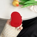 Close-up of red leather mango-shaped phone grip with embossed texture and fine stitching - Red