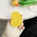 Detail of yellow lychee-textured leather phone socket with embossed text and stitching - Yellow