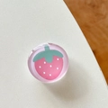 Top view of a round resin phone grip featuring a cute pink strawberry cartoon design - Transparent Stand Crystal Glass Pink Strawberry