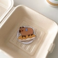 Detail showing cartoon capybara acrylic phone grip on white expandable airbag socket - Magnetic Versatile Capybara No.7 (Donut Base Style)