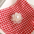 Detail view of a floral phone grip with white pearl center and iridescent resin petals - Transparent White