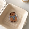 Macro shot of cute cartoon capybara acrylic phone holder in a natural paper box - Magnetic Versatile Capybara No.10 (Blue Scarf Style)