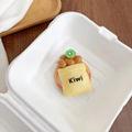 Gedetailleerde weergave van de creatieve 3D kiwi fruit tas telefoonhouder in doos - Zak Kiwi's