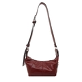 Minimalist deep red glossy leather baguette bag with adjustable strap and crescent shape - Red