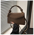Detail of brown geometric printed crossbody bag with a unique knotted top handle - Brown