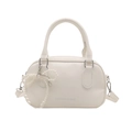 White faux leather bowling handbag with pearl bow charm and adjustable strap - White