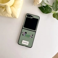 Detail of green pebble leather folding case with cute puppy embroidery and woven label - Leather Embroidery Dog-Green / Samsung Z Flip 3