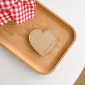 Detailed view of beige leather heart grip with stitch edges and engraved nice day text - Khaki