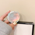 Detailed close-up of a holographic Hello Kitty resin phone grip with laser aurora finish - Magnetic Blue Light Cat Head