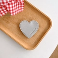 Detail of silver heart phone socket with Have A Nice Day embossing and stitching - Silver