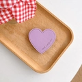 Detail of purple heart leather grip with Have A Nice Day text and fine stitching - Purple