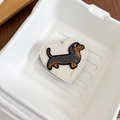 Detailed view of heart-shaped leather puppy embroidery patch with fine stitching - Beige