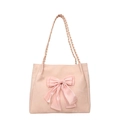 Pink tote bag featuring a large decorative bow and braided handles with a suede texture - Pink