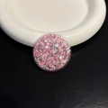 Dettaglio macro del supporto per telefono circolare con glitter rosa e argento - Cerchio Rosa