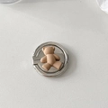 Macro shot of cute brown bear phone ring holder with a polished silver metal base - Coffee Bear