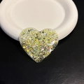 Macro shot of heart-shaped phone grip with gold glitter and green sequins in resin - Yellow Heart